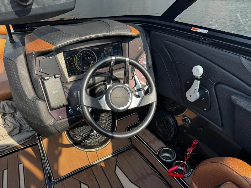 Slide: The Image of 2022 Centurion Fi23 boat dashboard with steering wheel and control panel. - 19