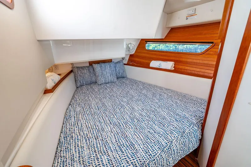 Slide: The Image of 2024 MJM 4 boat cabin with cozy bed and wooden accents. - 27