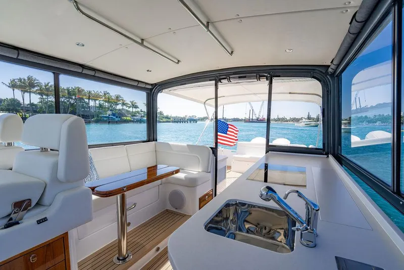 Slide: The Image of 2024 MJM 4 yacht interior with seating, sink, and ocean view. - 38