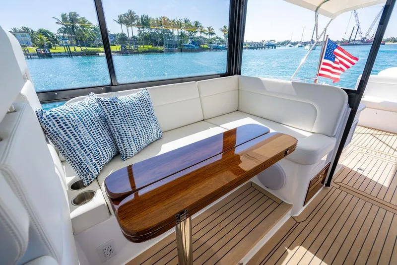 Slide: The Image of 2024 MJM 4 yacht interior with elegant seating, wooden table, and ocean view. - 39