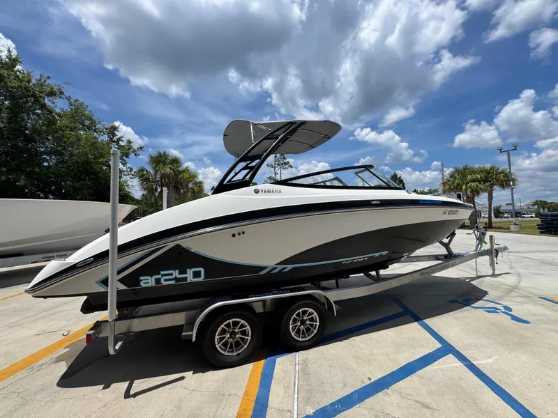 Slide: The Image of 2015 Yamaha AR240 HO boat on trailer under a partly cloudy sky. - 11