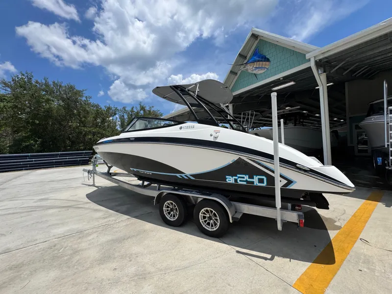 Slide: The Image of 2015 Yamaha AR240 HO boat on trailer under blue sky. - 18