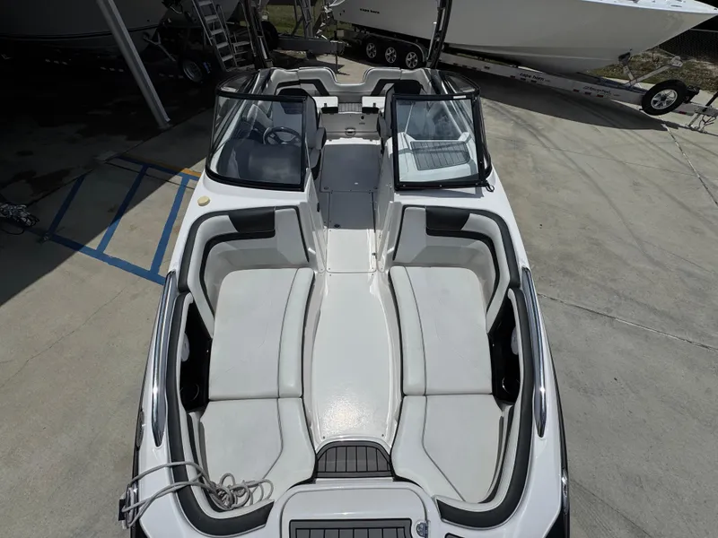 Slide: The Image of 2015 Yamaha Boats AR240 HO, white interior, docked on concrete surface. - 21