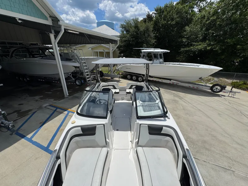 Slide: The Image of 2015 Yamaha Boats AR240 HO in a marina, surrounded by other boats. - 22