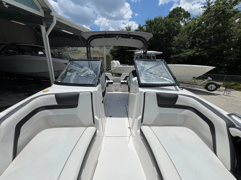 Slide: The Image of 2015 Yamaha Boats AR240 HO interior with seating, under a partly cloudy sky. - 23