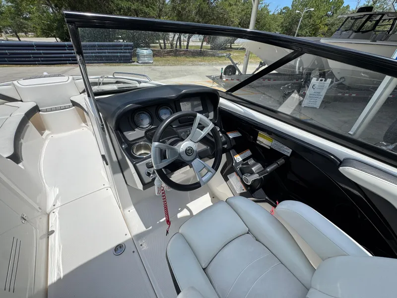 Slide: The Image of 2015 Yamaha Boats AR240 HO cockpit with steering wheel and controls, featuring modern design. - 25