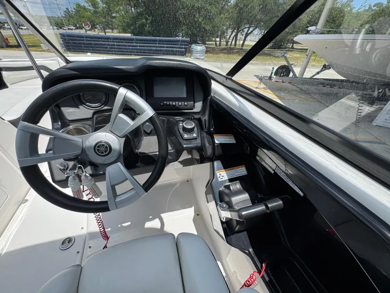 Slide: The Image of 2015 Yamaha Boats AR240 HO dashboard with steering wheel and controls. - 26