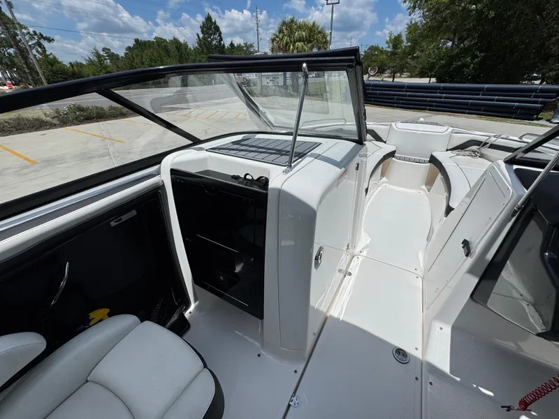 Slide: The Image of 2015 Yamaha Boats AR240 HO interior with seating and open deck under a clear sky. - 28