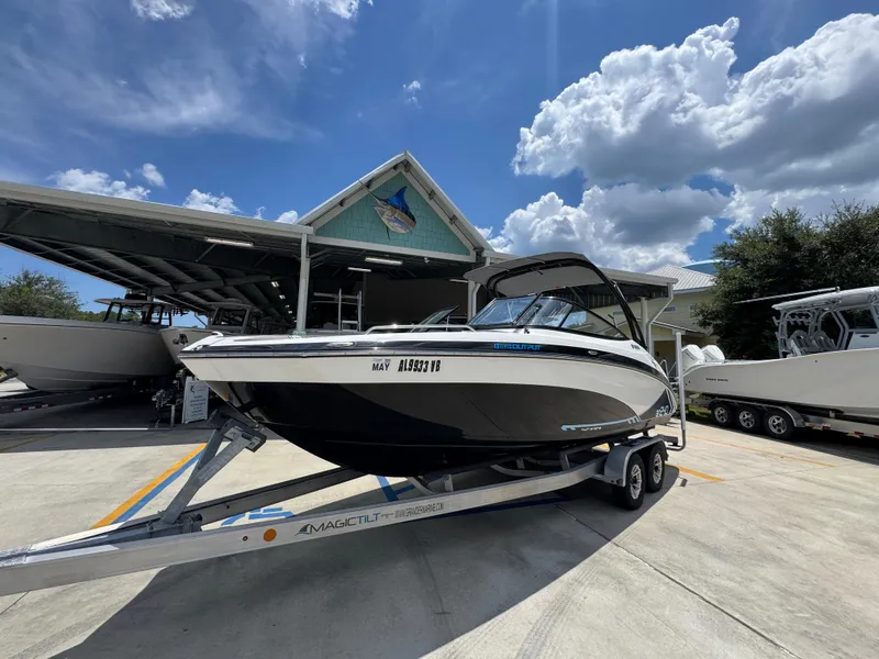 Slide: The Image of 2015 Yamaha Boats AR240 HO on trailer, parked outdoors under a partly cloudy sky. - 3