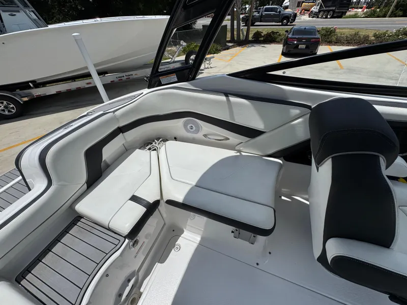 Slide: The Image of Interior of a 2015 Yamaha Boats AR240 HO, featuring sleek white and black seating. - 31