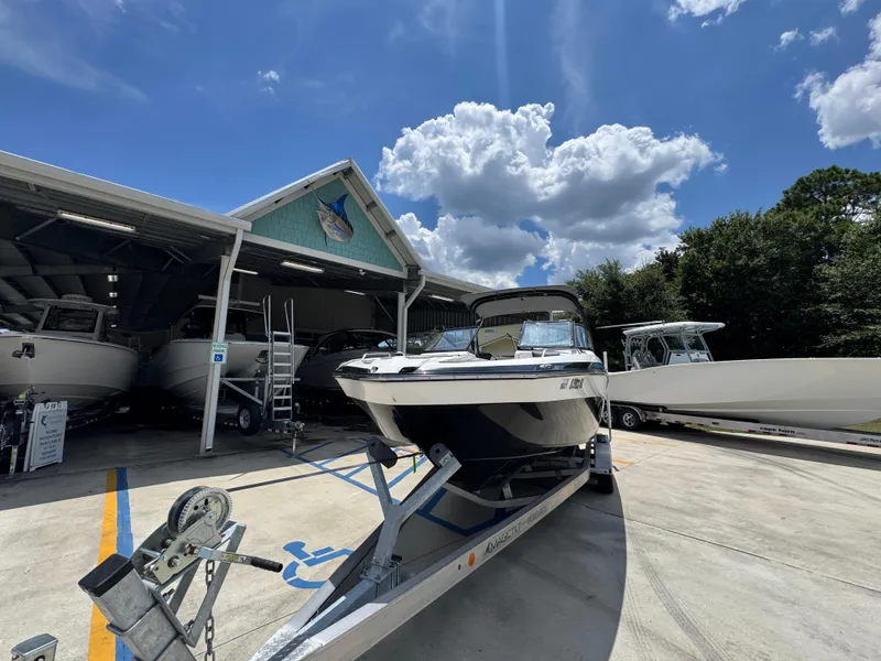 Slide: The Image of 2015 Yamaha AR240 HO boat on trailer under blue sky at marina. - 5