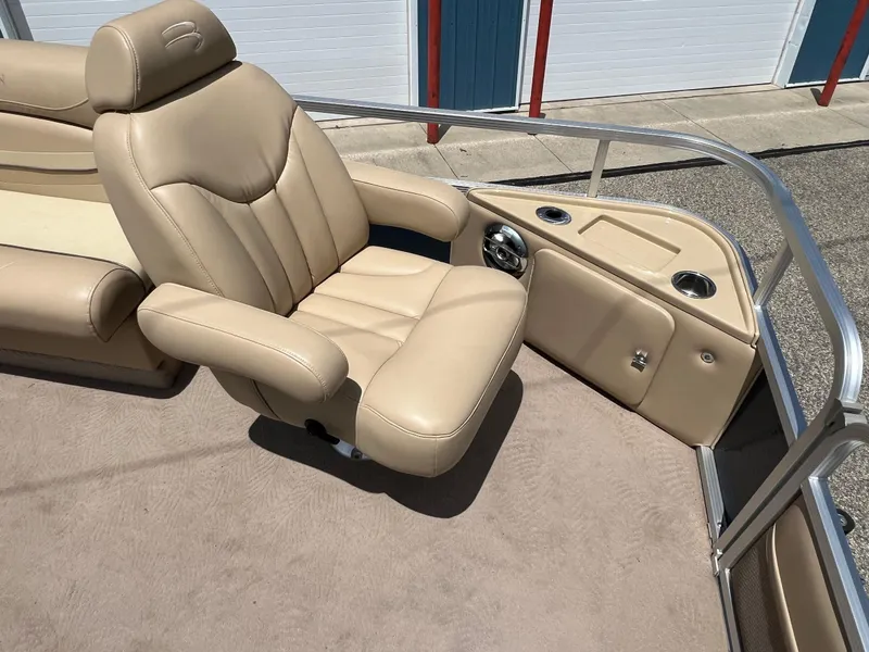 Slide: The Image of Beige captain's chair on 2008 Bennington R25 boat, featuring cup holders and storage. - 10