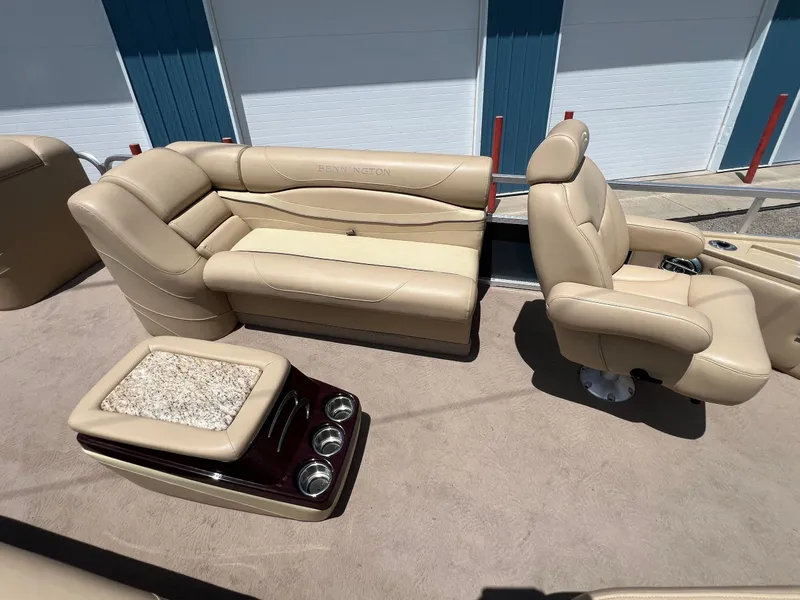 Slide: The Image of 2008 Bennington R25 boat interior with beige seating and cup holders. - 13