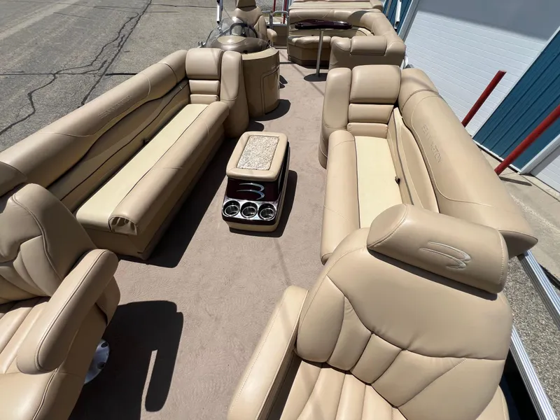 Slide: The Image of Luxurious interior of a 2008 Bennington R25 pontoon boat with beige seating and cup holders. - 14