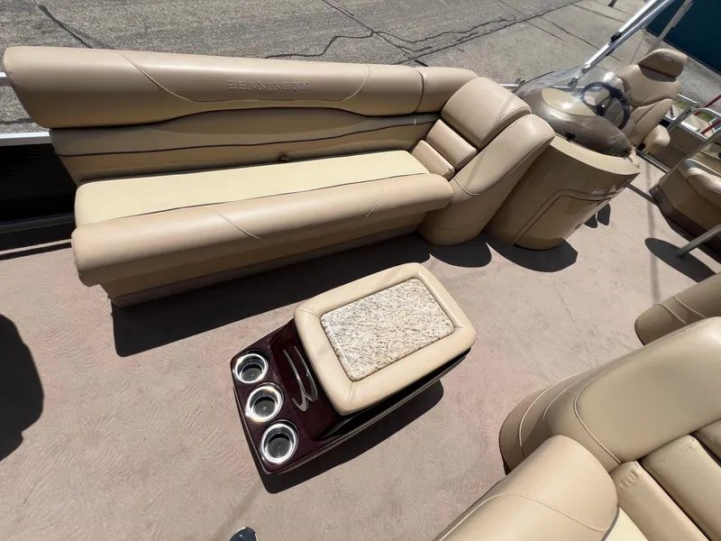 Slide: The Image of 2008 Bennington R25 boat interior with beige seating and cup holders. - 15