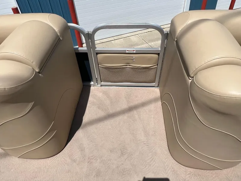 Slide: The Image of 2008 Bennington R25 boat interior with beige seating and metal gate. - 17