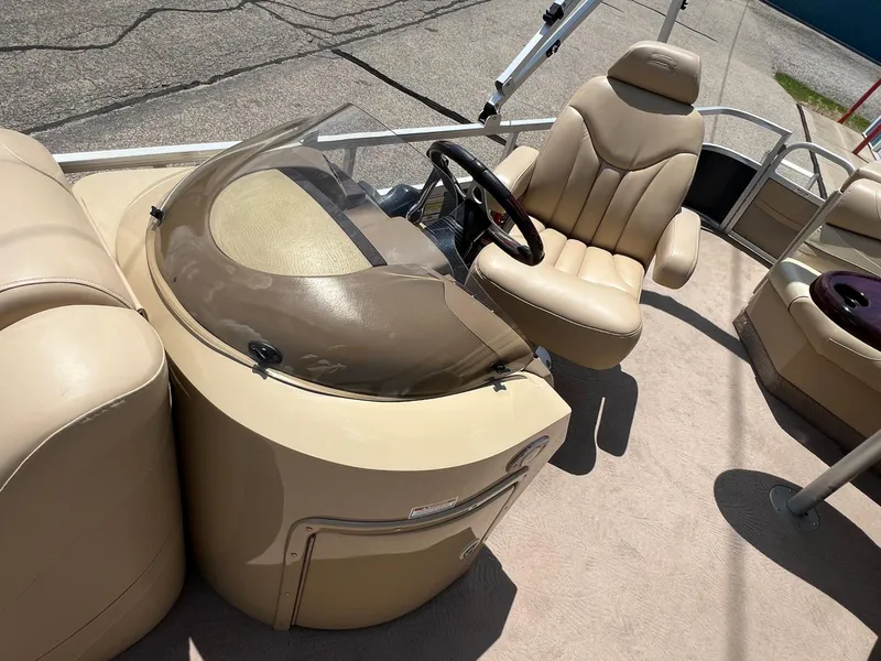 Slide: The Image of 2008 Bennington R25 boat interior with beige seating and steering console. - 18