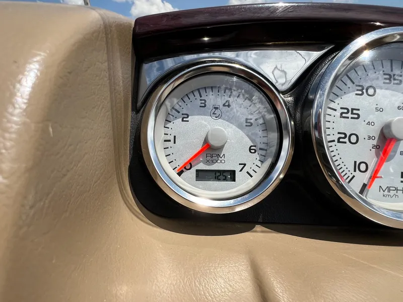 Slide: The Image of Close-up of 2008 Bennington R25 dashboard gauges, showing RPM and speedometer. - 22