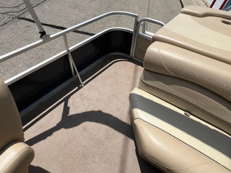 Slide: The Image of 2008 Bennington R25 pontoon boat interior with beige seating and carpet. - 26