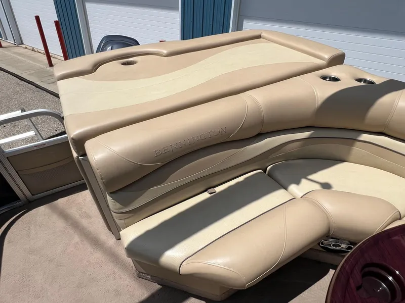 Slide: The Image of 2008 Bennington R25 boat with beige leather seating and cup holders. - 27