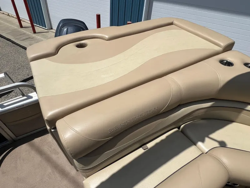Slide: The Image of Beige seating area on a 2008 Bennington R25 boat, featuring cup holders. - 28