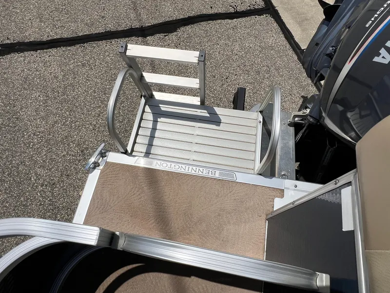 Slide: The Image of Bennington R25 2008 boat ladder and deck, featuring sturdy aluminum construction. - 29