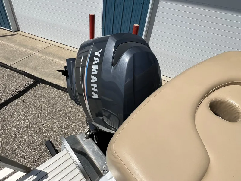Slide: The Image of Yamaha outboard motor on 2008 Bennington R25 boat, parked near storage units. - 30