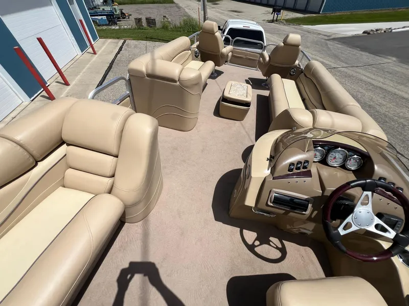 Slide: The Image of 2008 Bennington R25 pontoon boat interior with beige seating and steering console. - 34