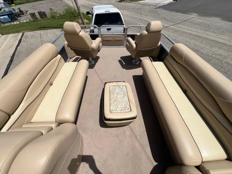 Slide: The Image of 2008 Bennington R25 pontoon boat interior with beige seating and central table. - 37