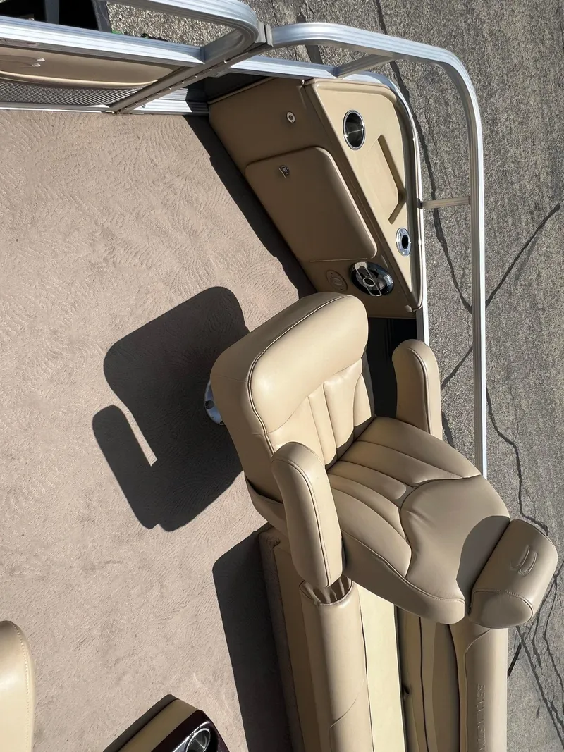 Slide: The Image of 2008 Bennington R25 boat interior with beige leather seating and steering console. - 9