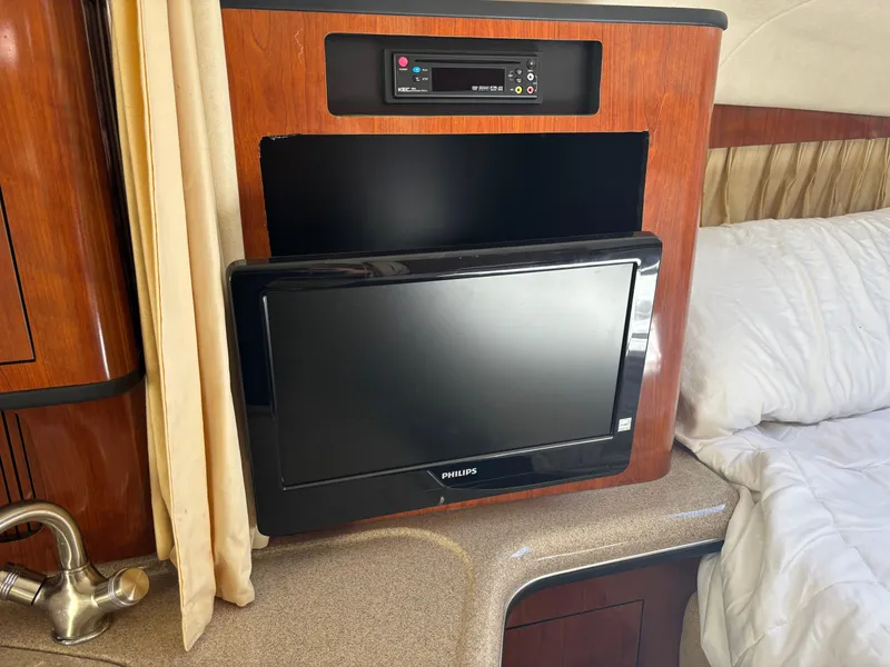 Slide: The Image of Interior of 2006 Sea Ray 300 Sundancer with TV and entertainment system. - 16