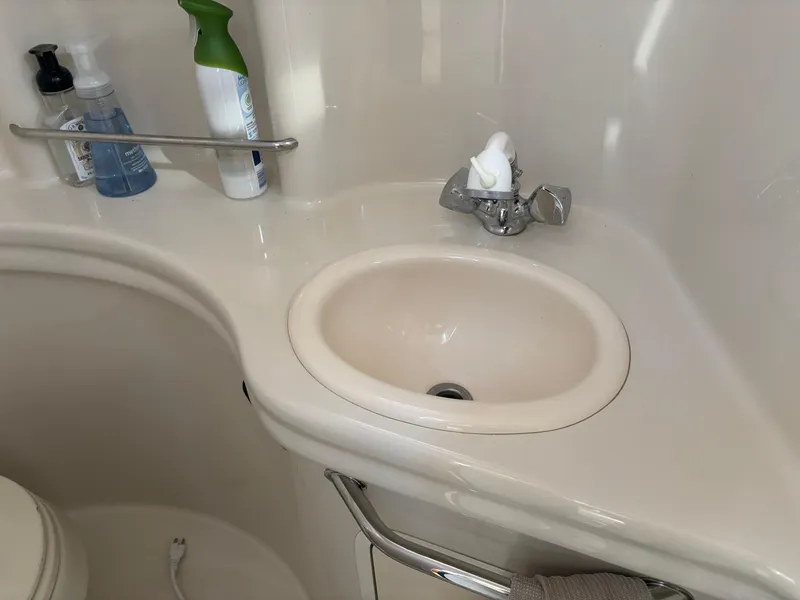 Slide: The Image of Bathroom sink area on a 2006 Sea Ray 300 Sundancer boat. - 21