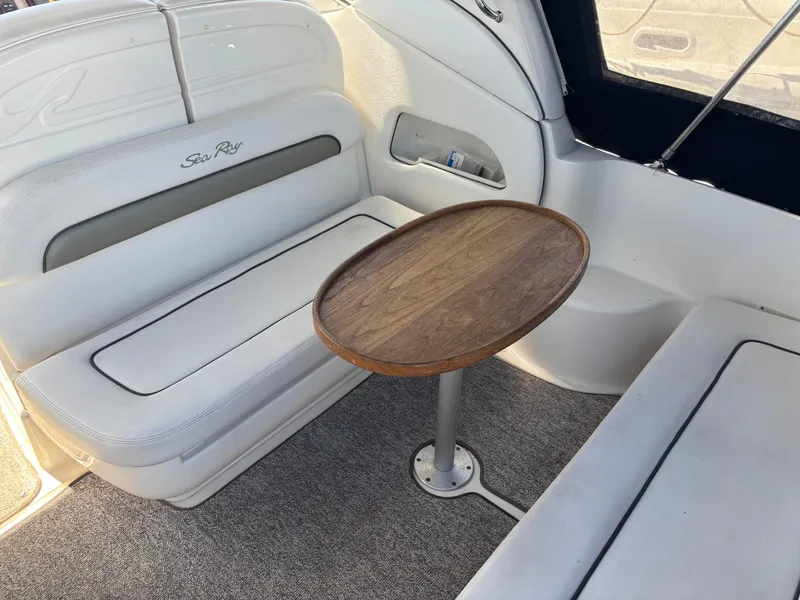 Slide: The Image of Interior of 2006 Sea Ray 300 Sundancer with seating and wooden table. - 7