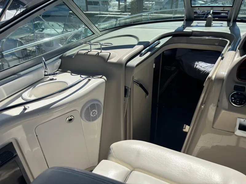 Slide: The Image of 2006 Sea Ray 300 Sundancer interior with sink, cabin entrance, and seating area. - 9