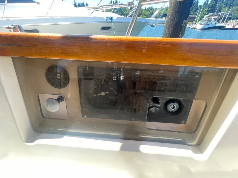 Slide: The Image of Control panel of a 1995 Island Packet 40 sailboat, featuring gauges and switches. - 10