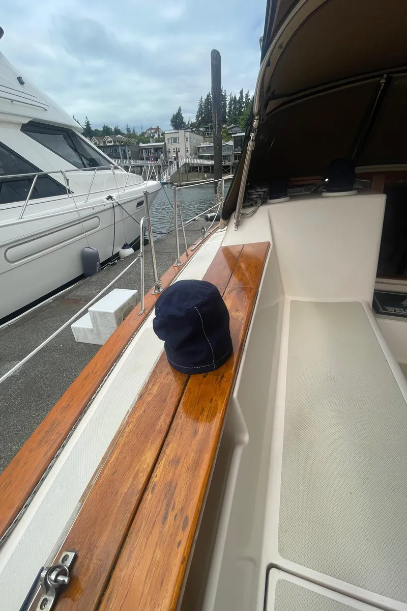 Slide: The Image of Island Packet 40 sailboat deck with wooden trim, docked at marina, 1995 model. - 11