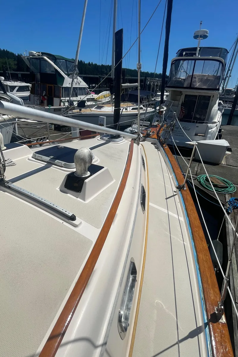 Slide: The Image of Island Packet 40 sailboat, 1995 model, docked at marina under clear blue sky. - 14