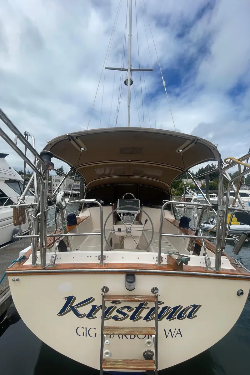 Slide: The Image of Island Packet 40 sailboat, 1995 model, docked with a covered cockpit and clear sky above. - 16