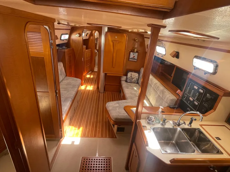 Slide: The Image of Interior of 1995 Island Packet 40 sailboat with wood finish and cozy seating area. - 19