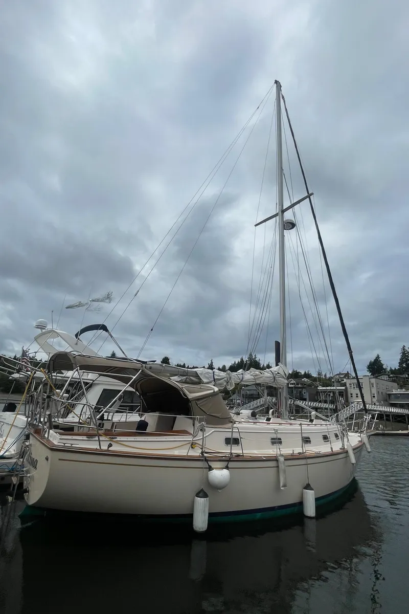 Slide: The Image of 1995 Island Packet 40 sailboat docked under cloudy skies. - 2