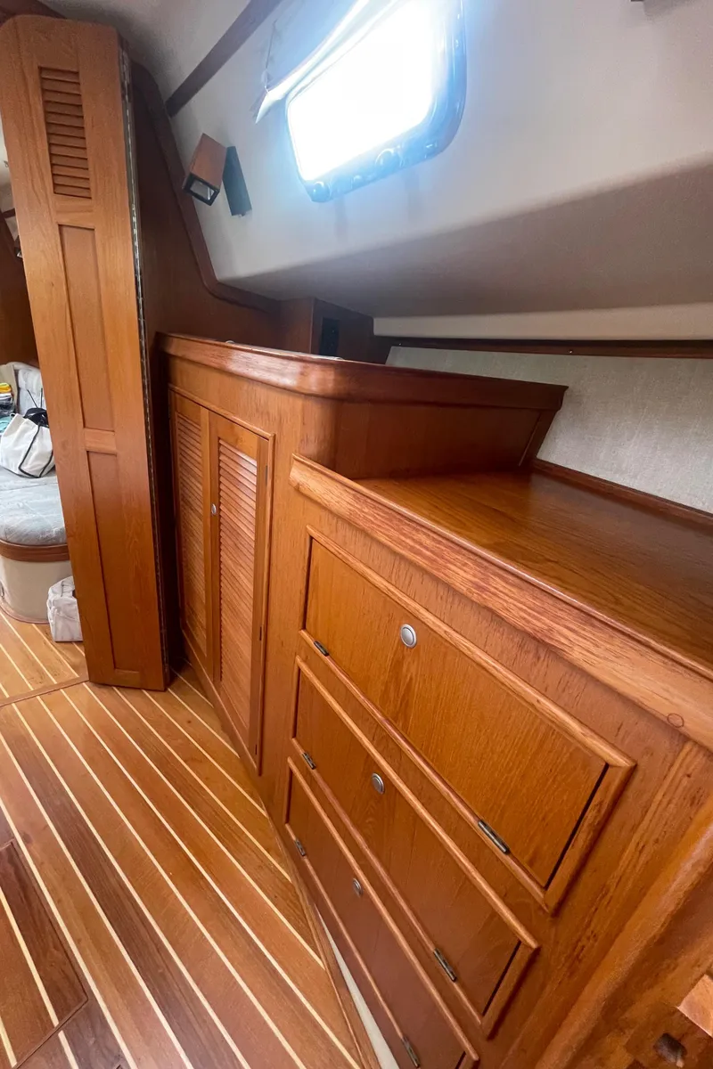 Slide: The Image of Interior of 1995 Island Packet 40 sailboat with wooden cabinetry and striped flooring. - 34