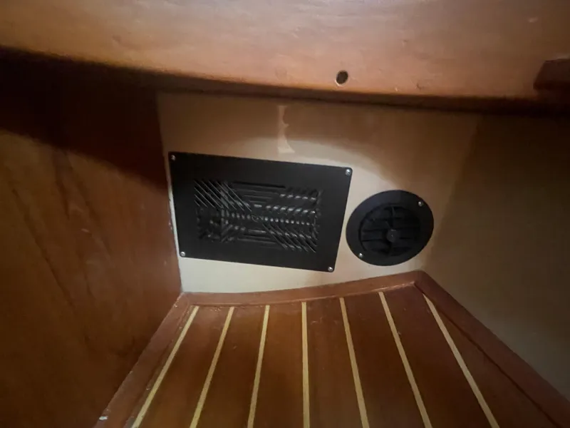 Slide: The Image of Wooden interior of a 1995 Island Packet 40 sailboat with vent and speaker. - 36