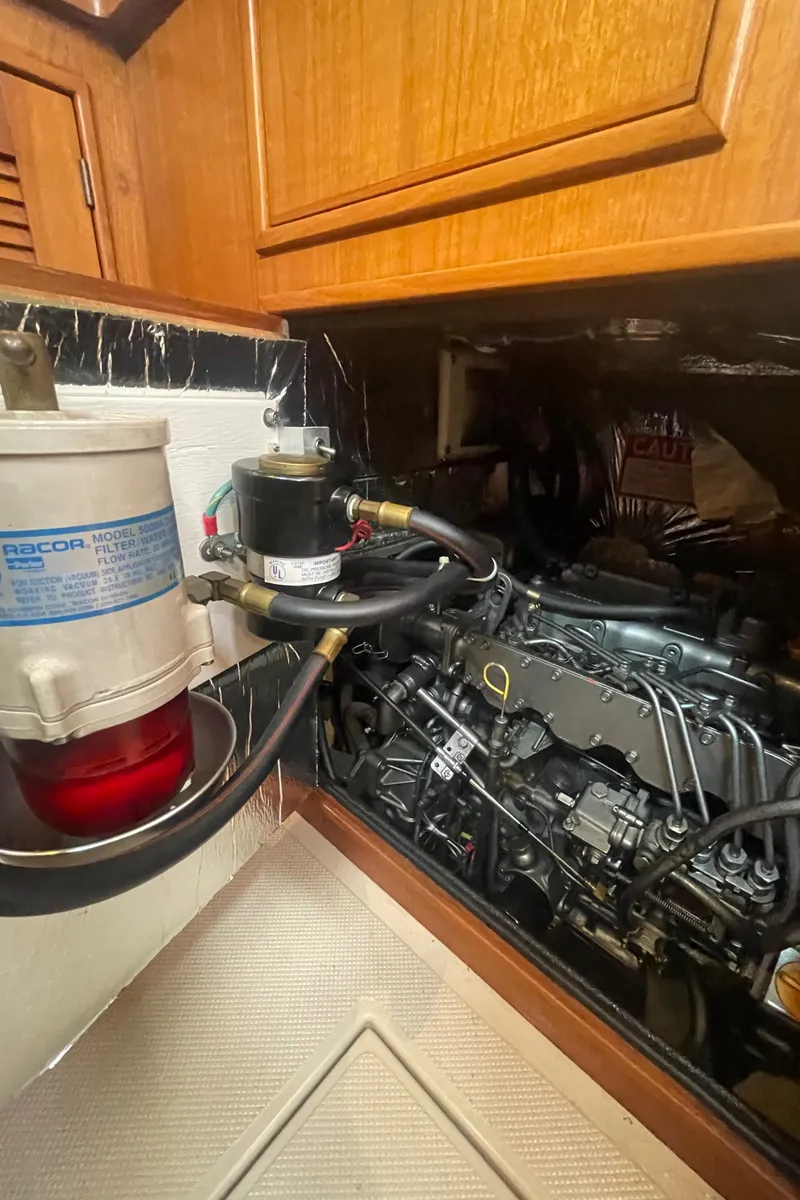 Slide: The Image of Engine compartment of a 1995 Island Packet 40 sailboat, featuring a Racor fuel filter. - 39