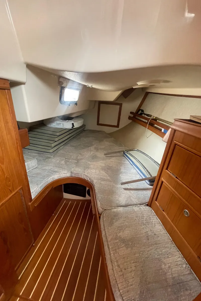 Slide: The Image of 1995 Island Packet 40 interior cabin with wooden finishes and cozy sleeping area. - 43