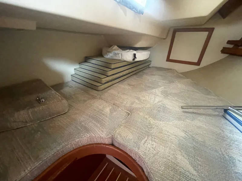 Slide: The Image of Interior cabin of 1995 Island Packet 40 sailboat with cushioned seating and storage. - 44