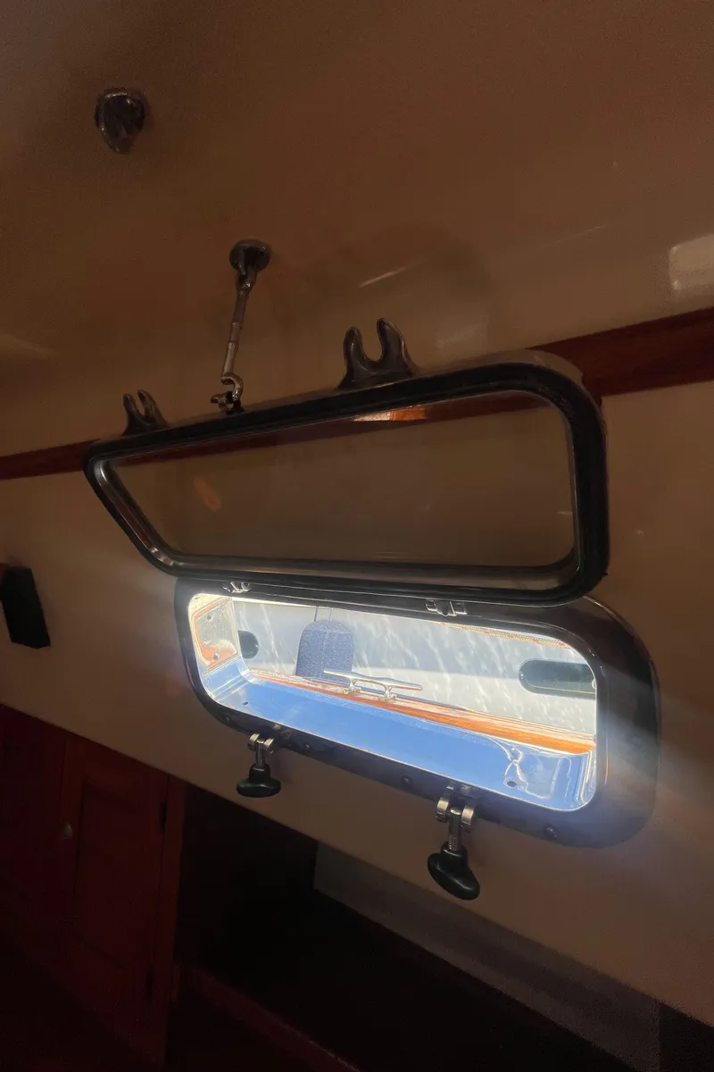 Slide: The Image of Open porthole on 1995 Island Packet 40 sailboat, sunlight streaming through. - 45