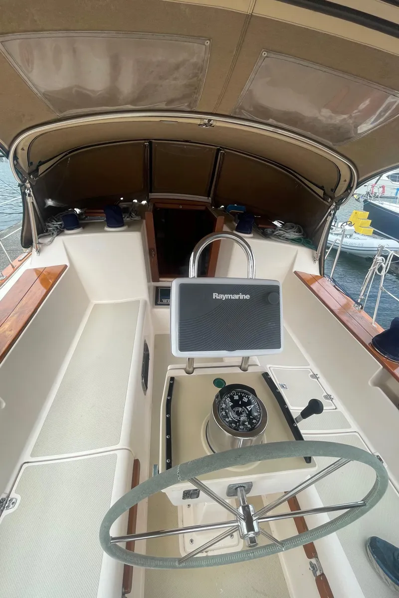 Slide: The Image of Cockpit of 1995 Island Packet 40 sailboat with steering wheel and navigation equipment. - 5