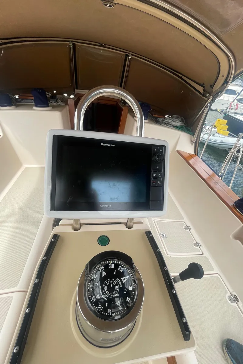 Slide: The Image of Cockpit of 1995 Island Packet 40 sailboat with compass and Raymarine navigation display. - 6