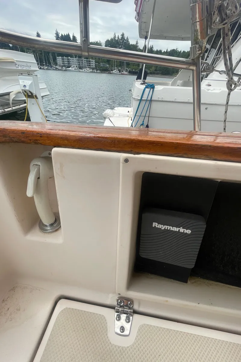 Slide: The Image of 1995 Island Packet 40 sailboat cockpit with Raymarine equipment, docked at marina. - 8