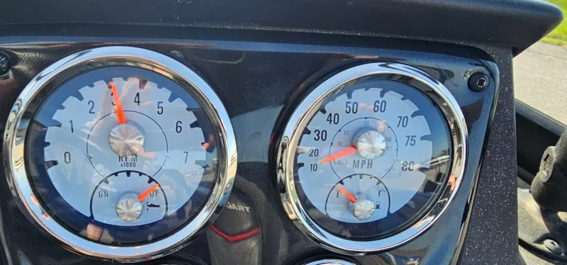 Slide: The Image of Dashboard of 2022 Tracker Tagra V19 showing tachometer and speedometer. - 13